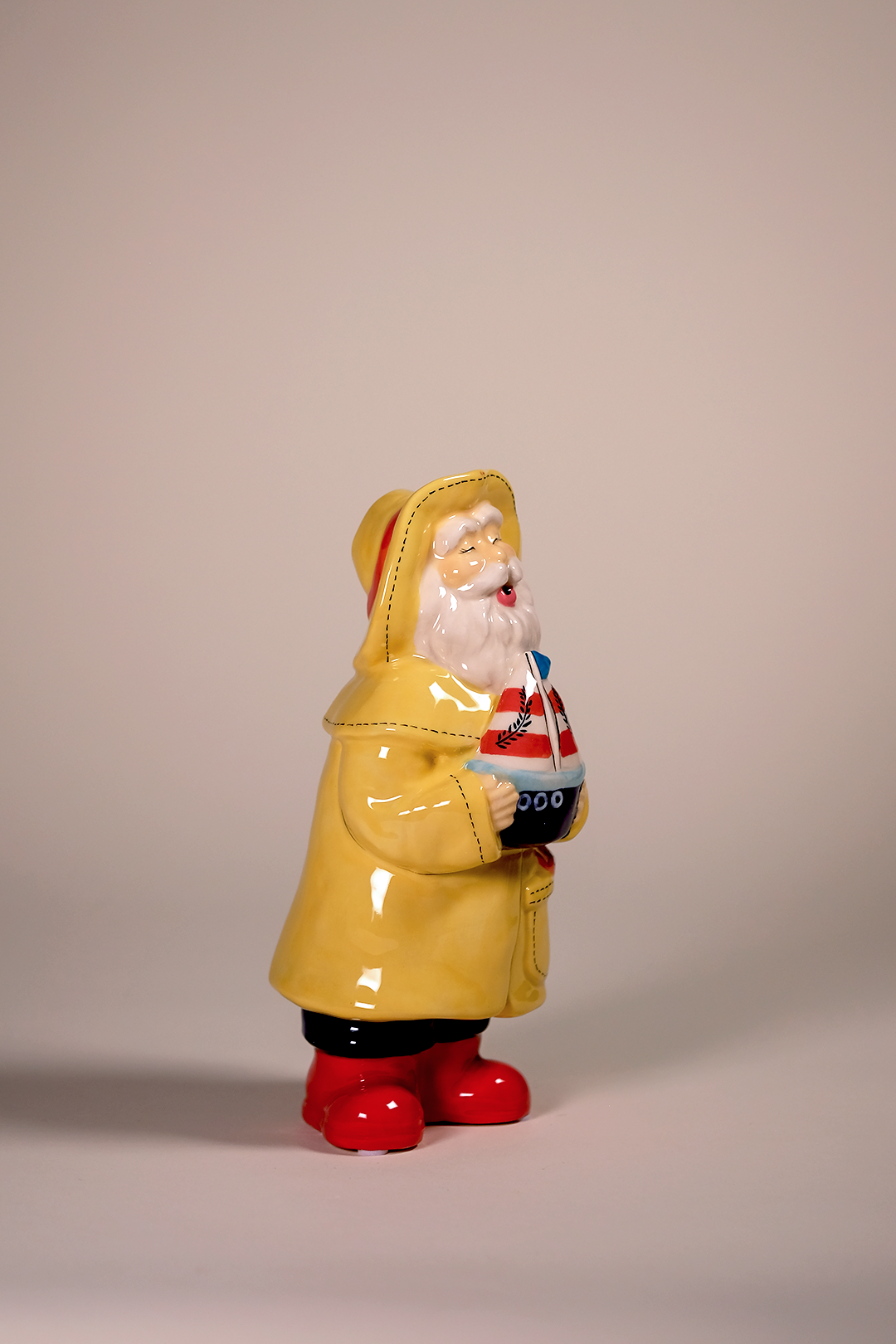 Man Holds the Sailboat Figurine