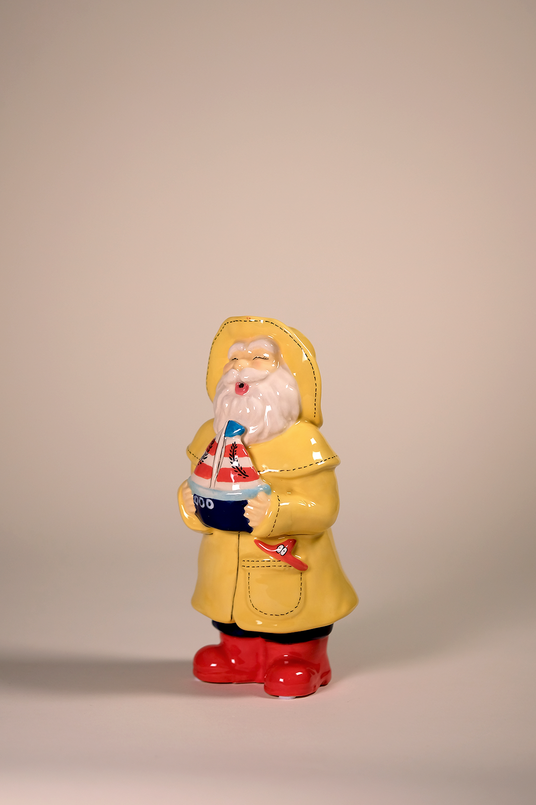 Man Holds the Sailboat Figurine